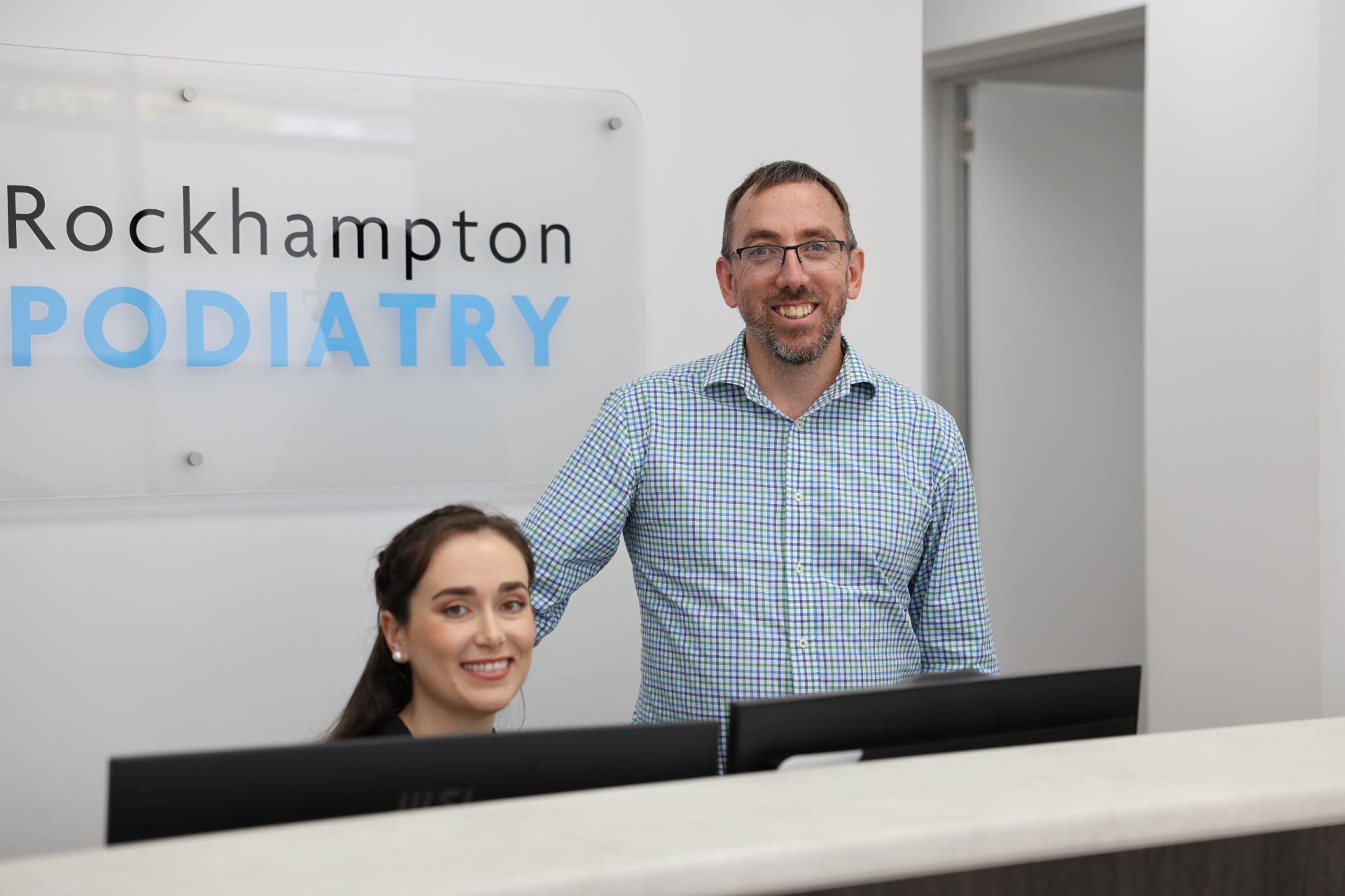 Matt Cavanagh and Kelsey Pettett at the Rockhampton Podiatry reception desk